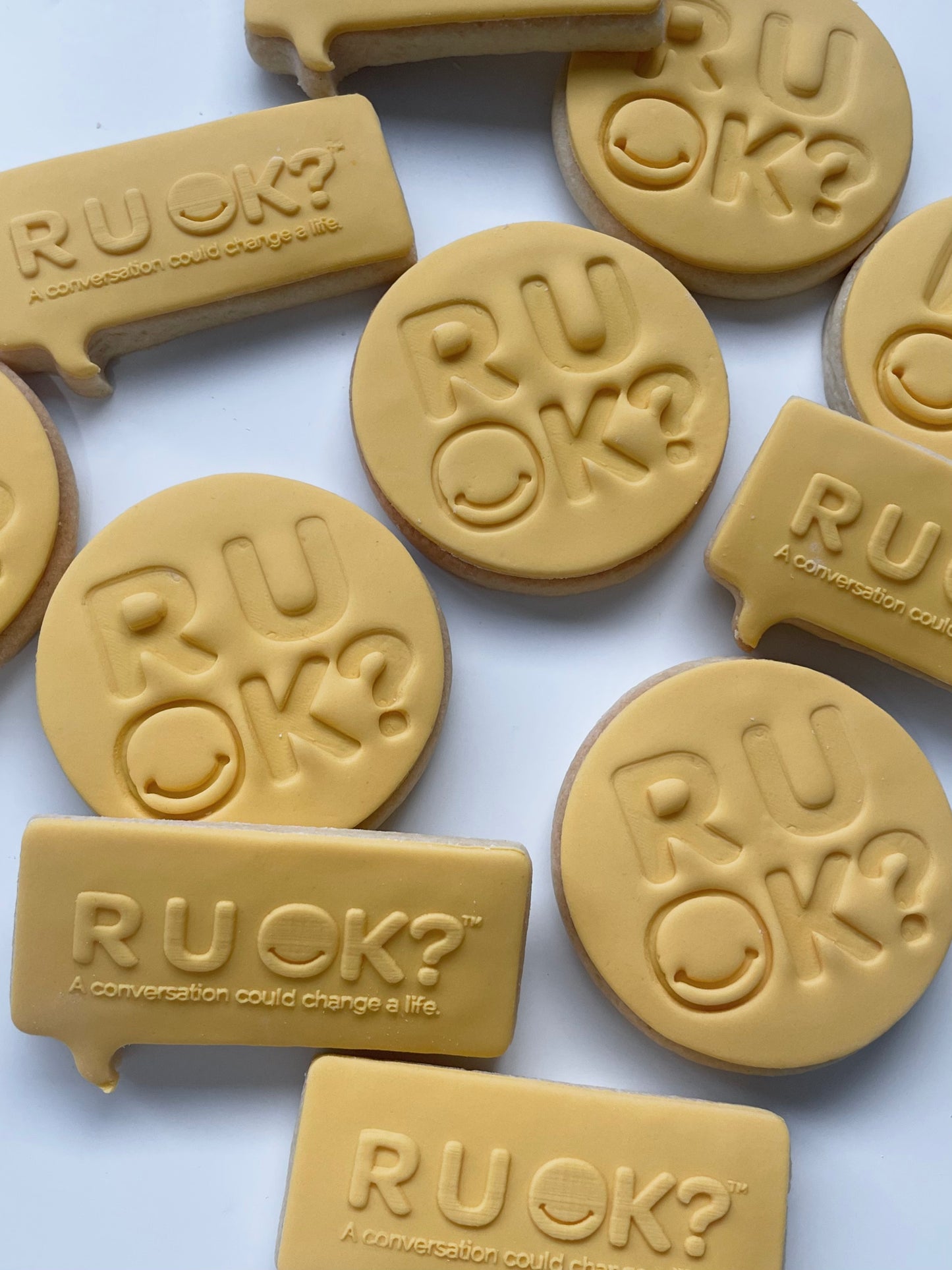 Freshly baked R U OK cookies from My Little Bake Co, displayed on a plate with a golden-brown appearance.